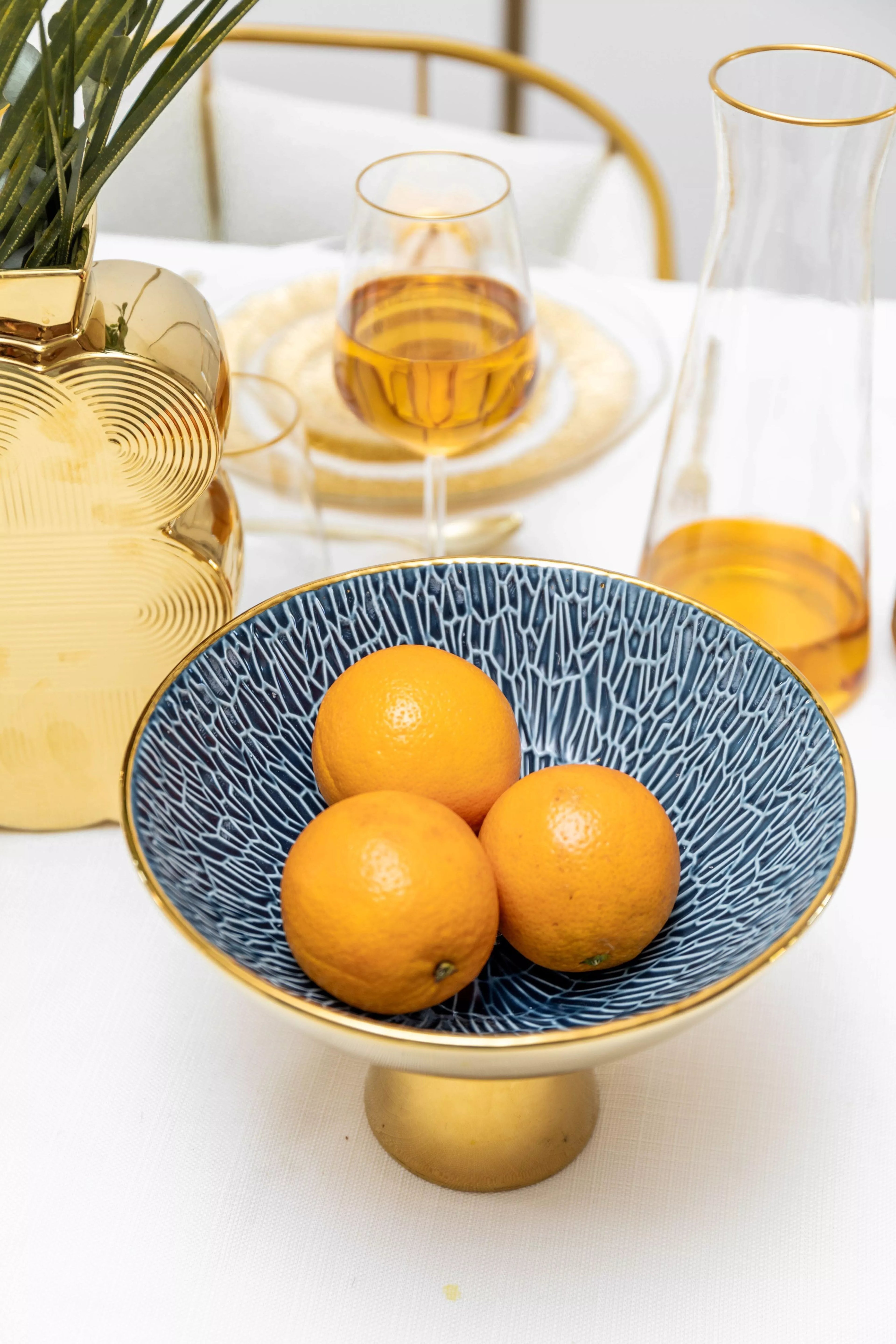 Gold and blue fruit bowl on foot